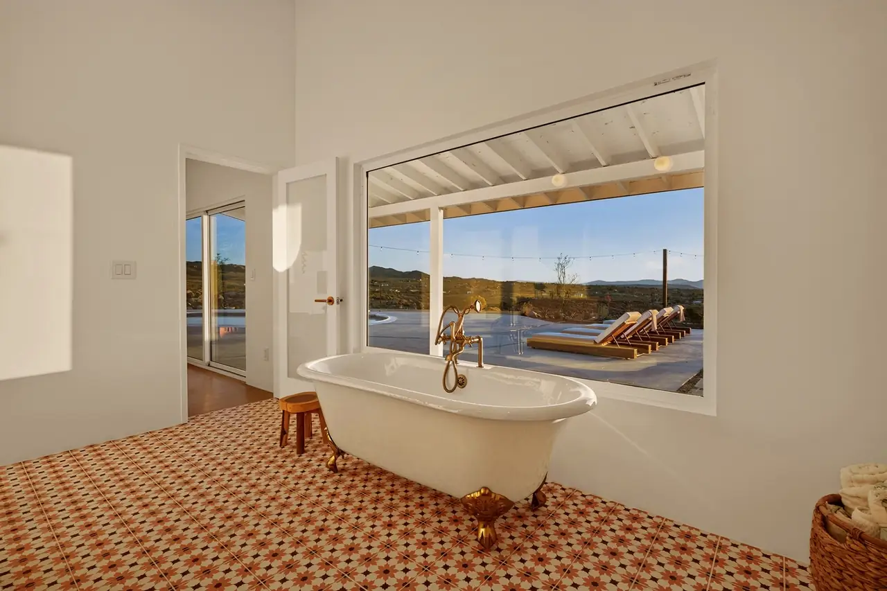 Primary bath with clawfoot tub and desert view