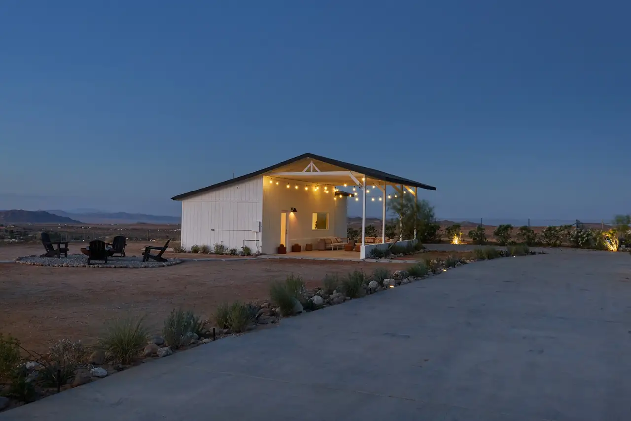 Illuminated casita with string lights and firepit at dusk