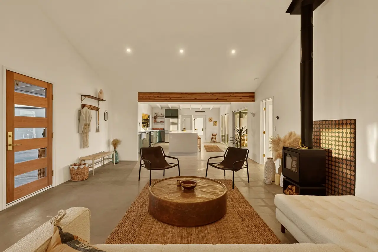 Living room open to kitchen with wood stove